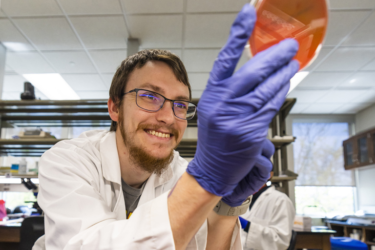 A IU South Bend student works in a microbiology lab.